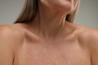 Photo of Mature woman with healthy skin on grey background, closeup