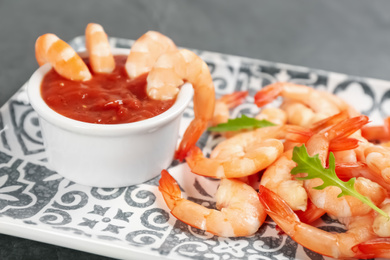 Photo of Delicious shrimp cocktail with tomato sauce, closeup