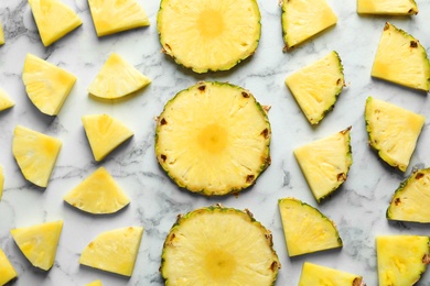 Flat lay composition with fresh sliced pineapple on marble background