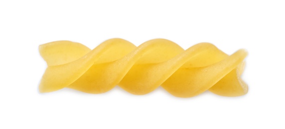 Uncooked fusilli pasta on white background, top view