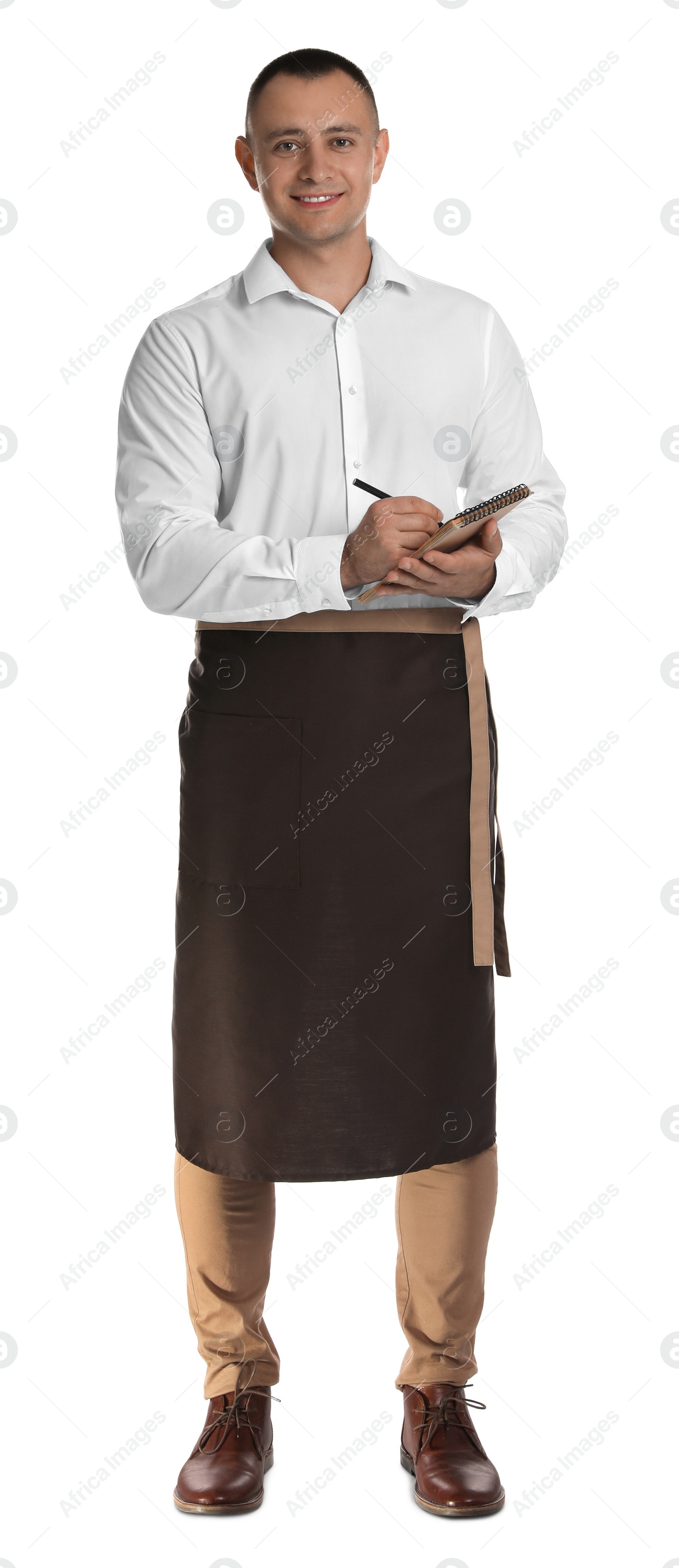 Photo of Full length portrait of happy young waiter with notebook on white background
