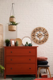 Photo of Stylish room interior with chest of drawers