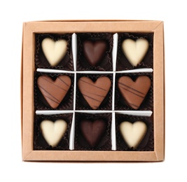 Photo of Tasty heart shaped chocolate candies in box isolated on white, top view. Valentine's day celebration