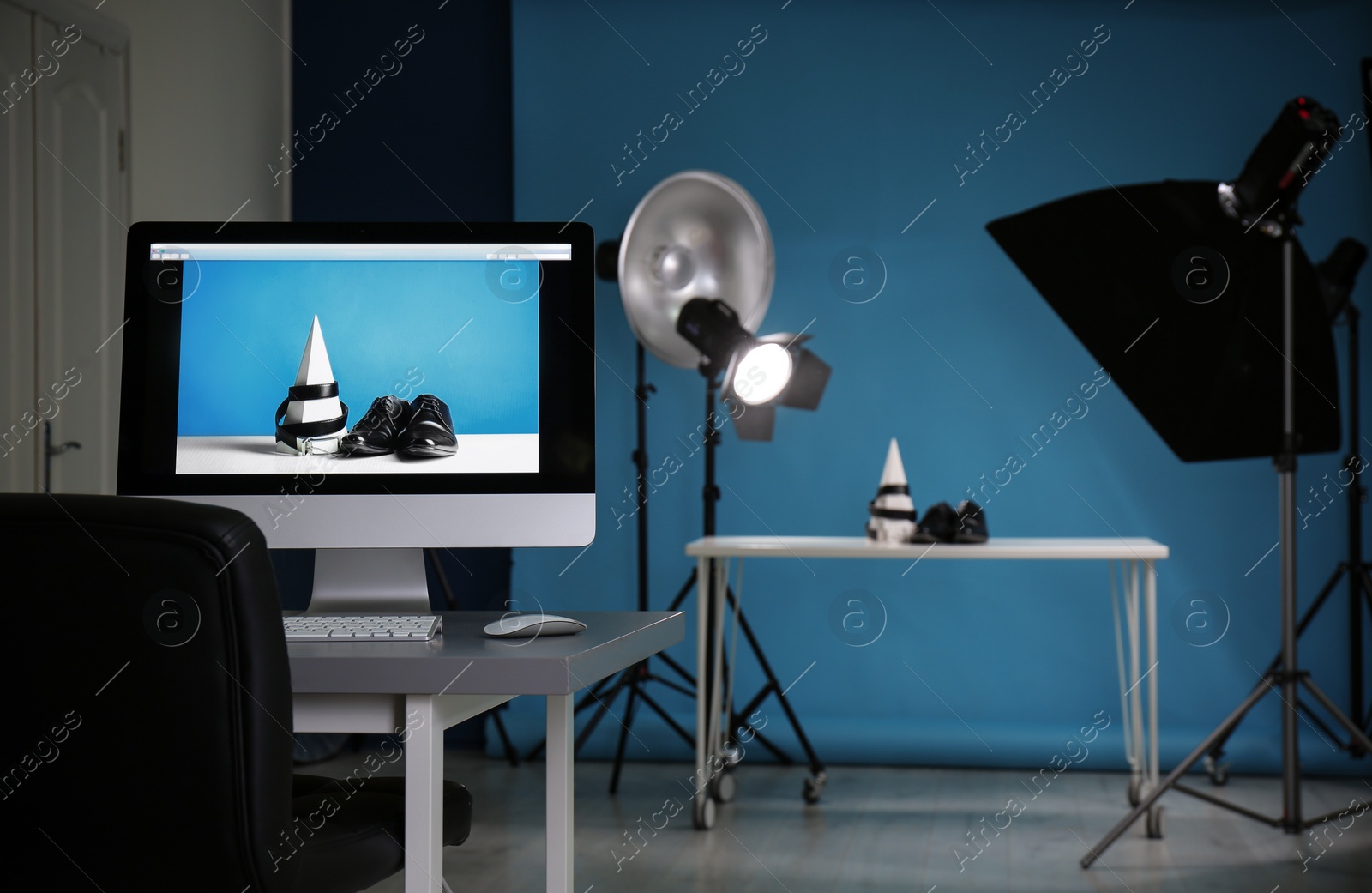 Photo of Shooting of men's shoes and belt for product promotion in photo studio, focus on PC screen