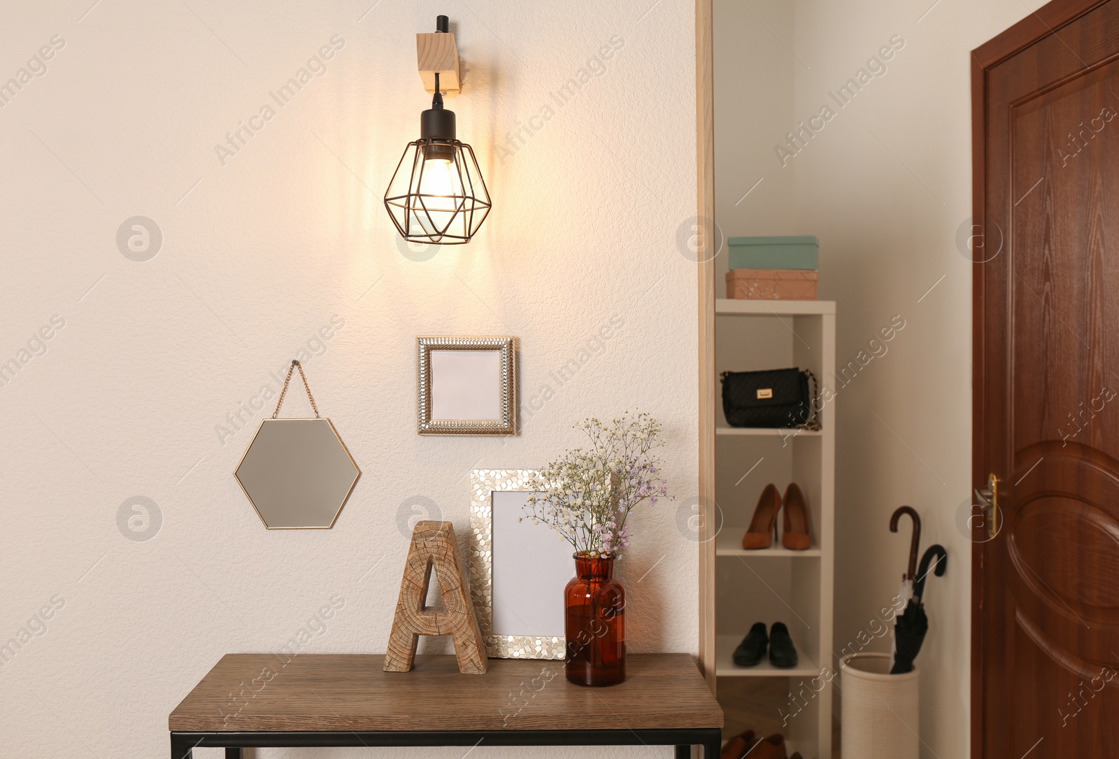 Photo of Modern hallway interior with stylish console table and shoe storage
