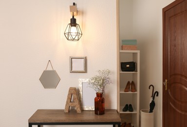 Modern hallway interior with stylish console table and shoe storage