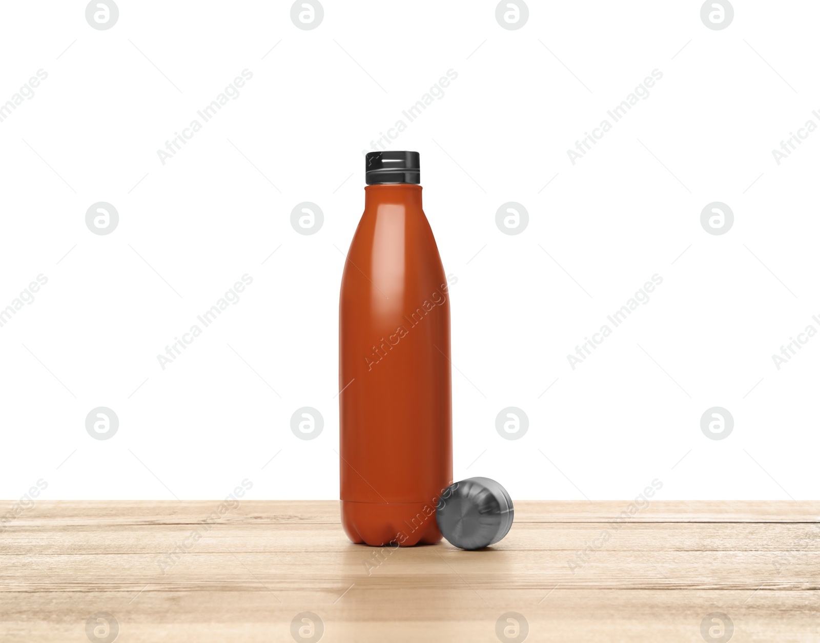 Photo of Stylish thermo bottle on wooden table against white background