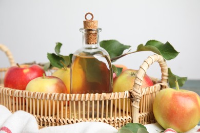 Photo of Natural apple vinegar and fresh fruits on tray