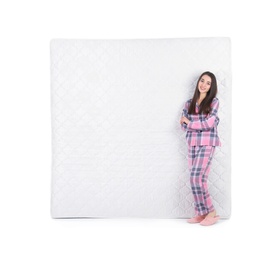 Young woman with comfortable mattress isolated on white