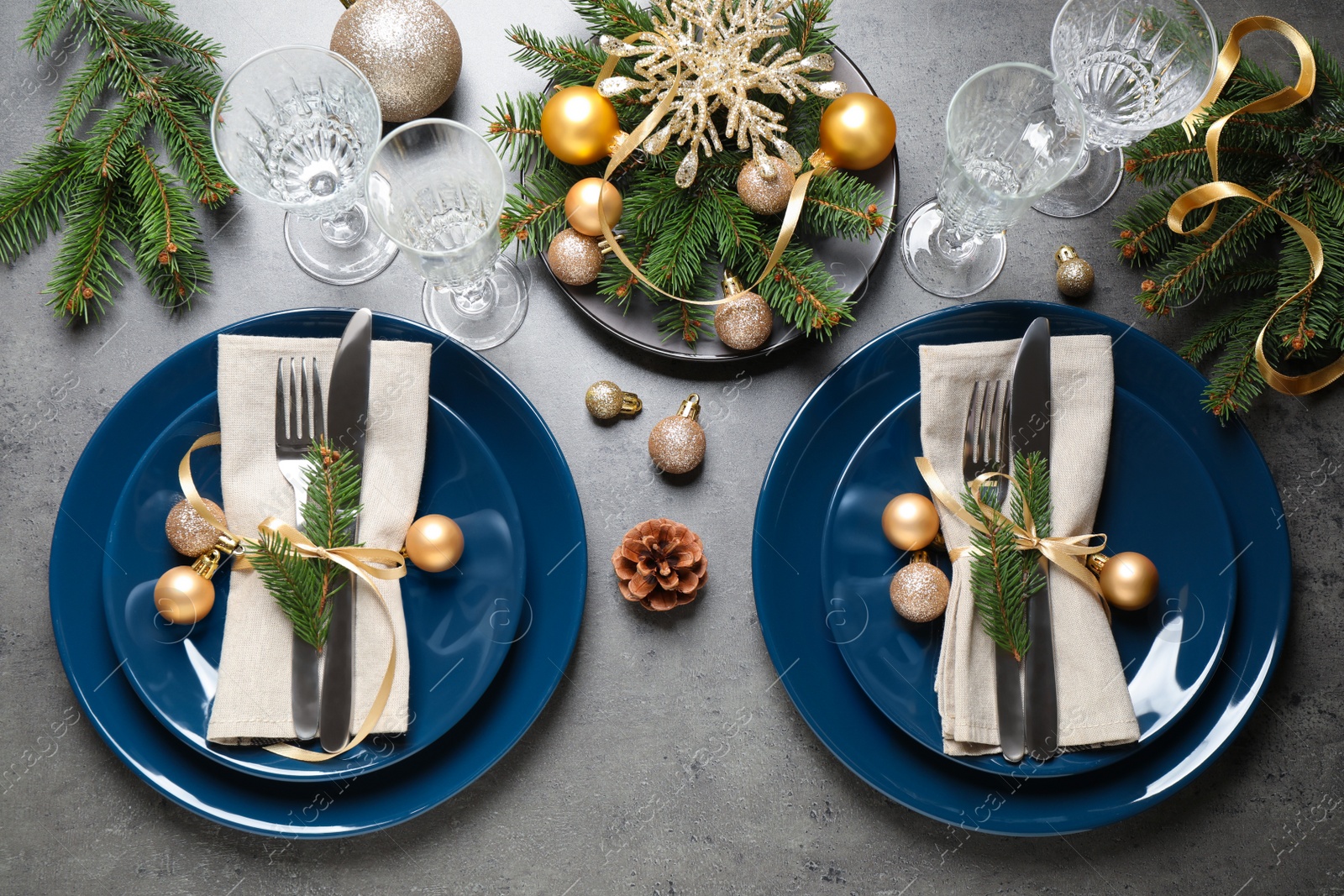 Photo of Festive table setting with beautiful dishware and Christmas decor on grey background, flat lay