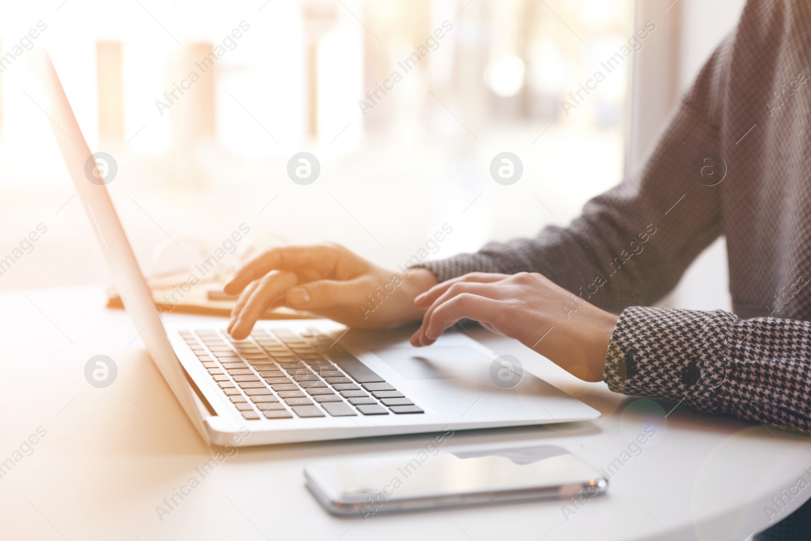 Image of Woman working with laptop at table indoors, closeup