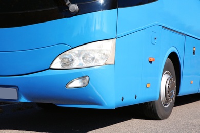 Photo of Modern blue bus on road, focus on headlight. Passenger transportation