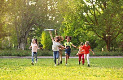 Photo of Cute little children playing with kite outdoors on sunny day