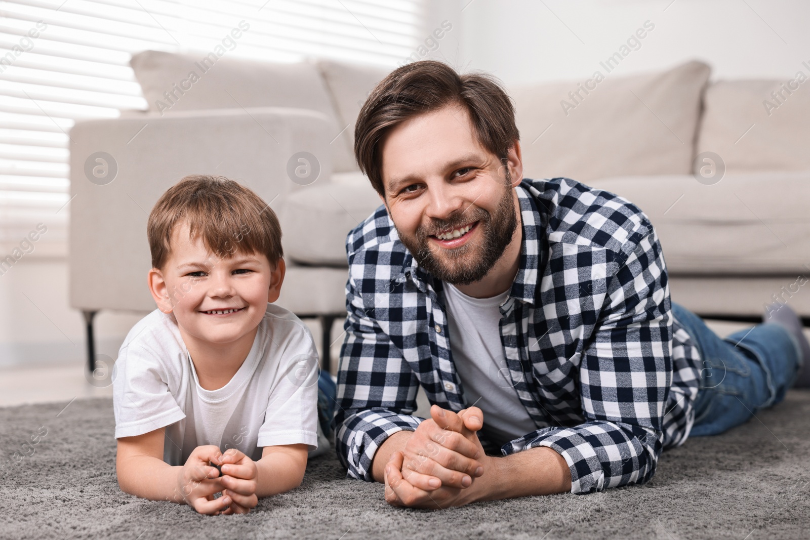 Photo of Family portrait of happy dad and son at home