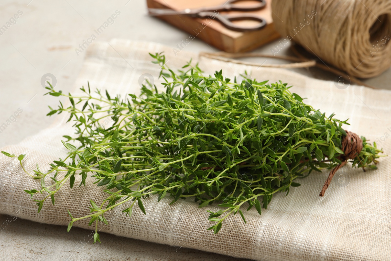 Photo of Bunch of aromatic thyme on light table