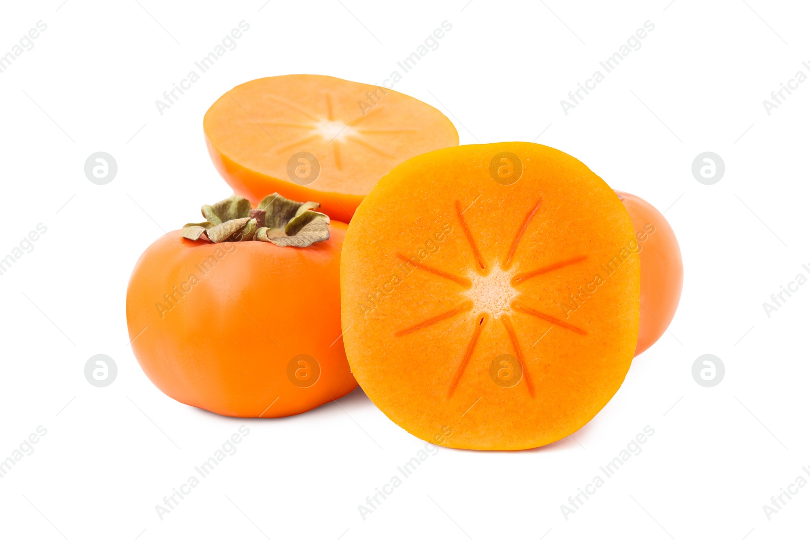 Photo of Whole and cut delicious ripe juicy persimmons on white background