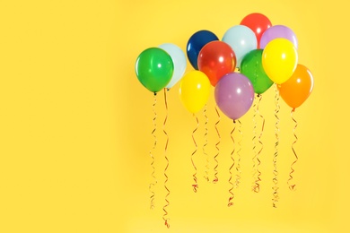 Photo of Bright balloons on color background, space for text. Celebration time