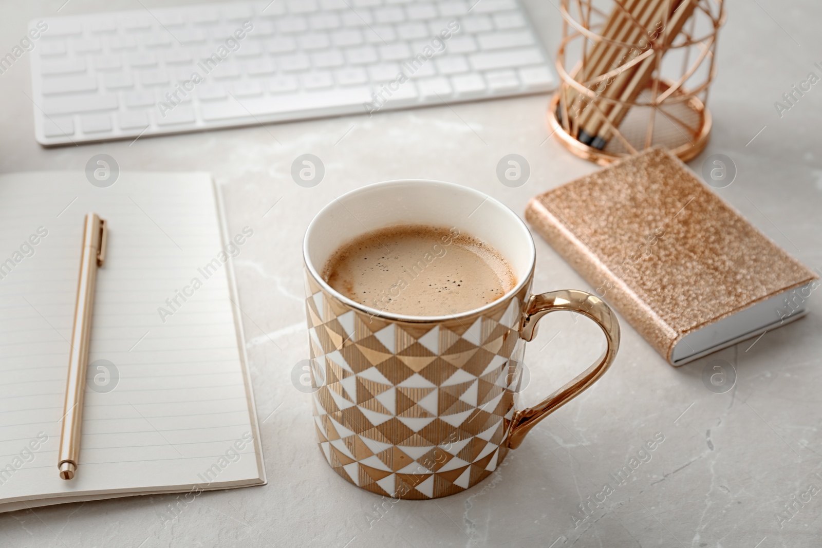 Photo of Cup of delicious hot coffee on table