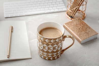 Cup of delicious hot coffee on table