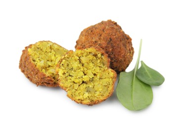 Photo of Delicious falafel balls and basil isolated on white