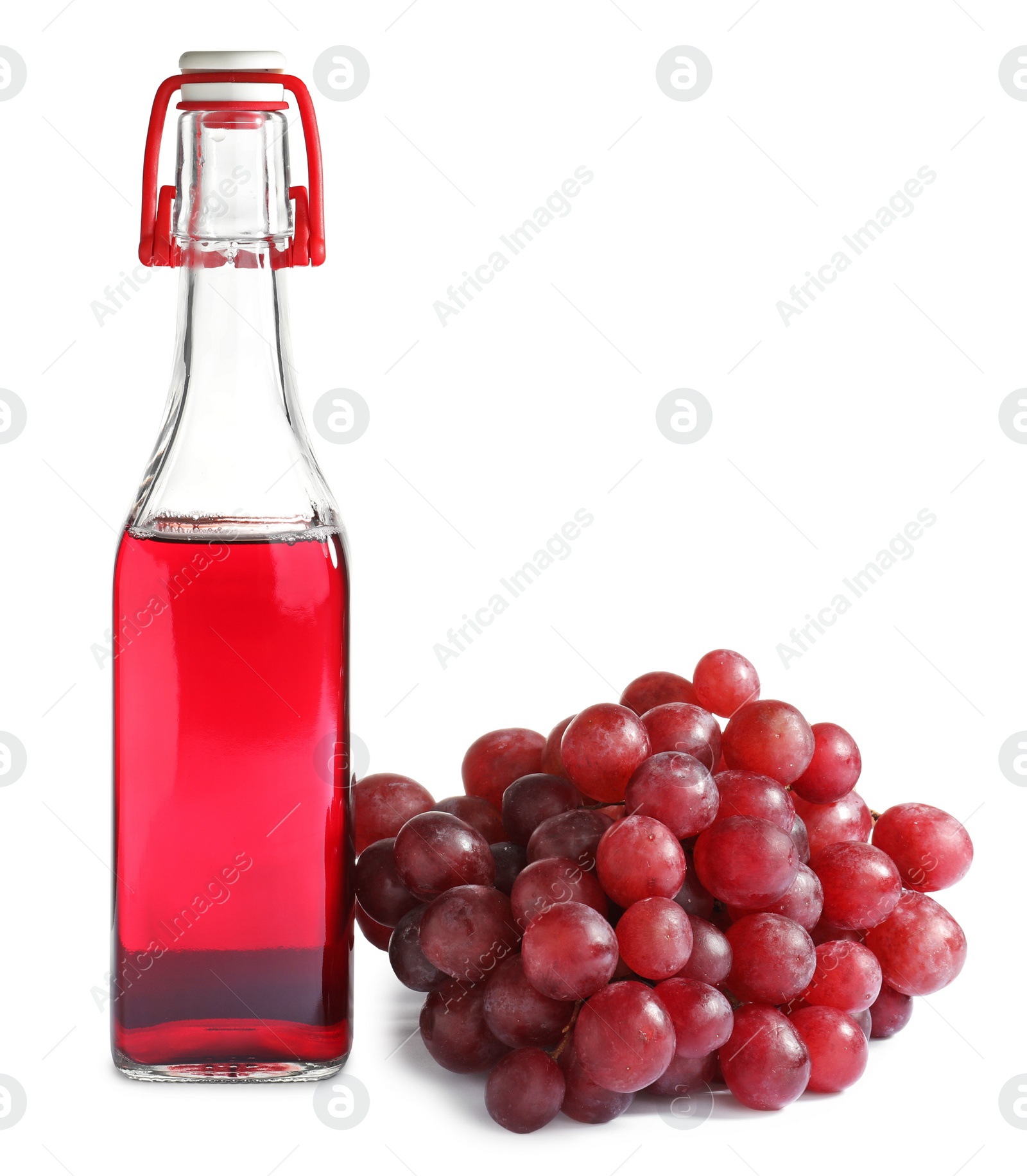 Photo of Bottle with wine vinegar and fresh grapes on white background