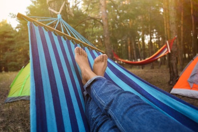 Photo of Woman resting in comfortable hammock outdoors, closeup