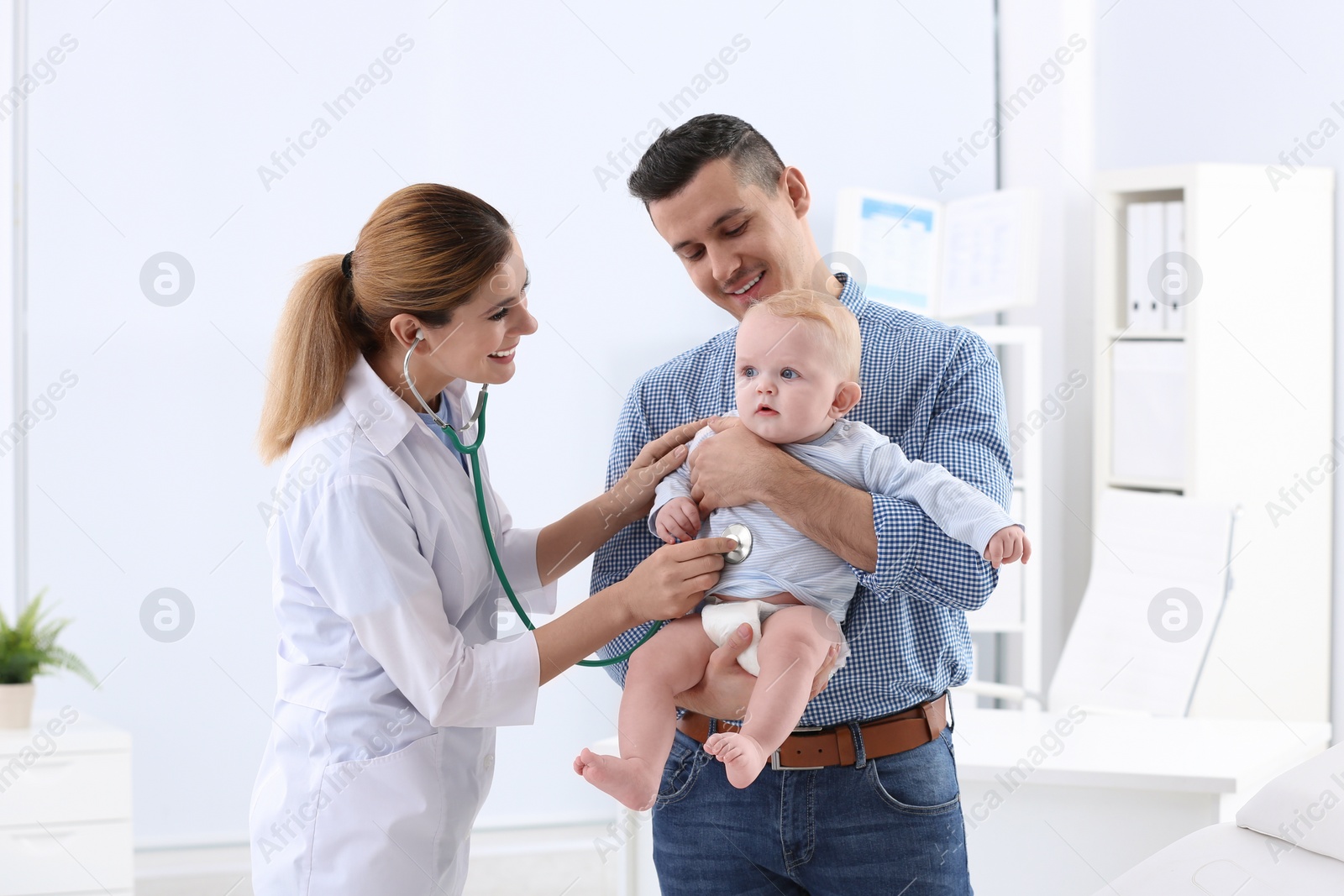 Photo of Man with his baby visiting children's doctor in hospital