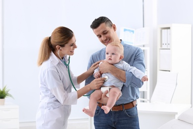 Man with his baby visiting children's doctor in hospital