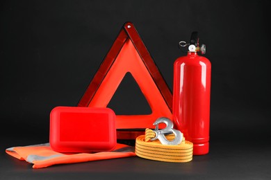 Photo of Set of car safety equipment on black background