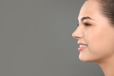 Portrait of young woman with beautiful face and natural makeup on color background, closeup. Space for text