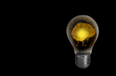 Lamp bulb with human brain inside on black background, space for text. Idea generation