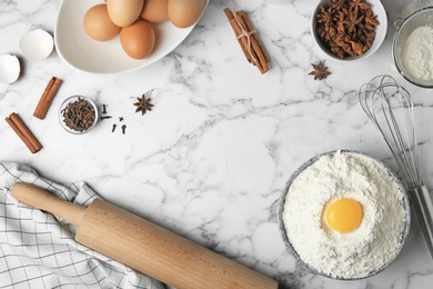 Photo of Flat lay composition with flour, eggs and spices on light grey background