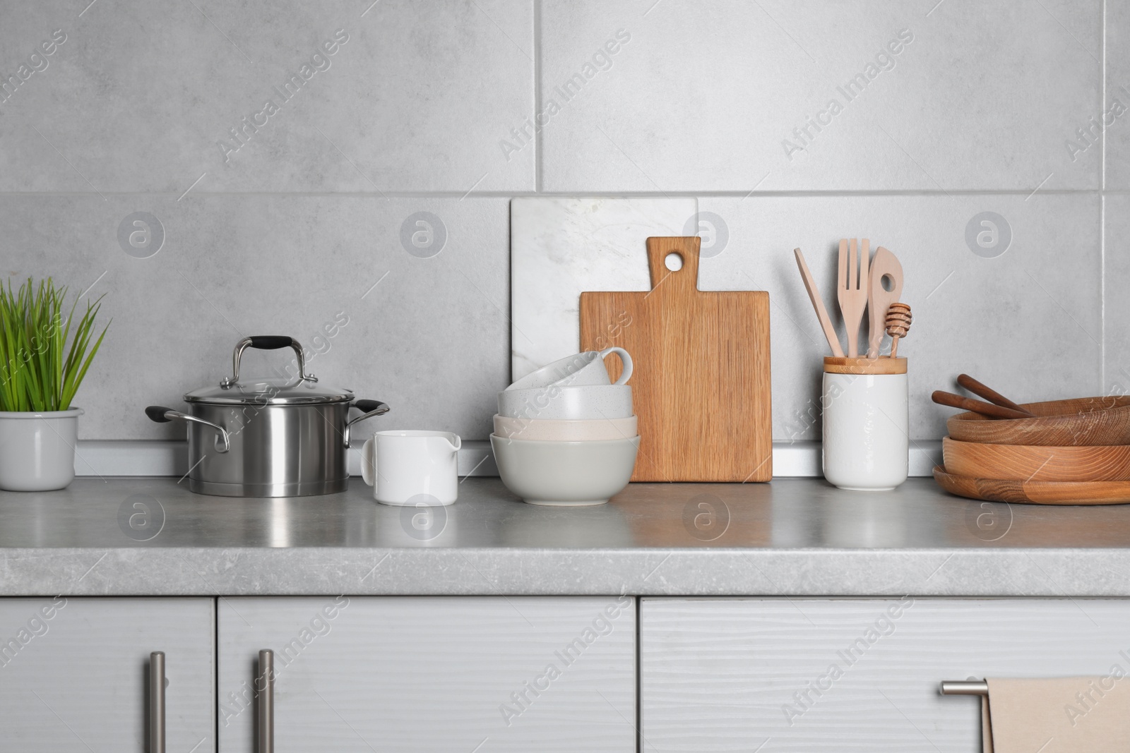 Photo of Cooking utensils and other kitchenware on grey countertop