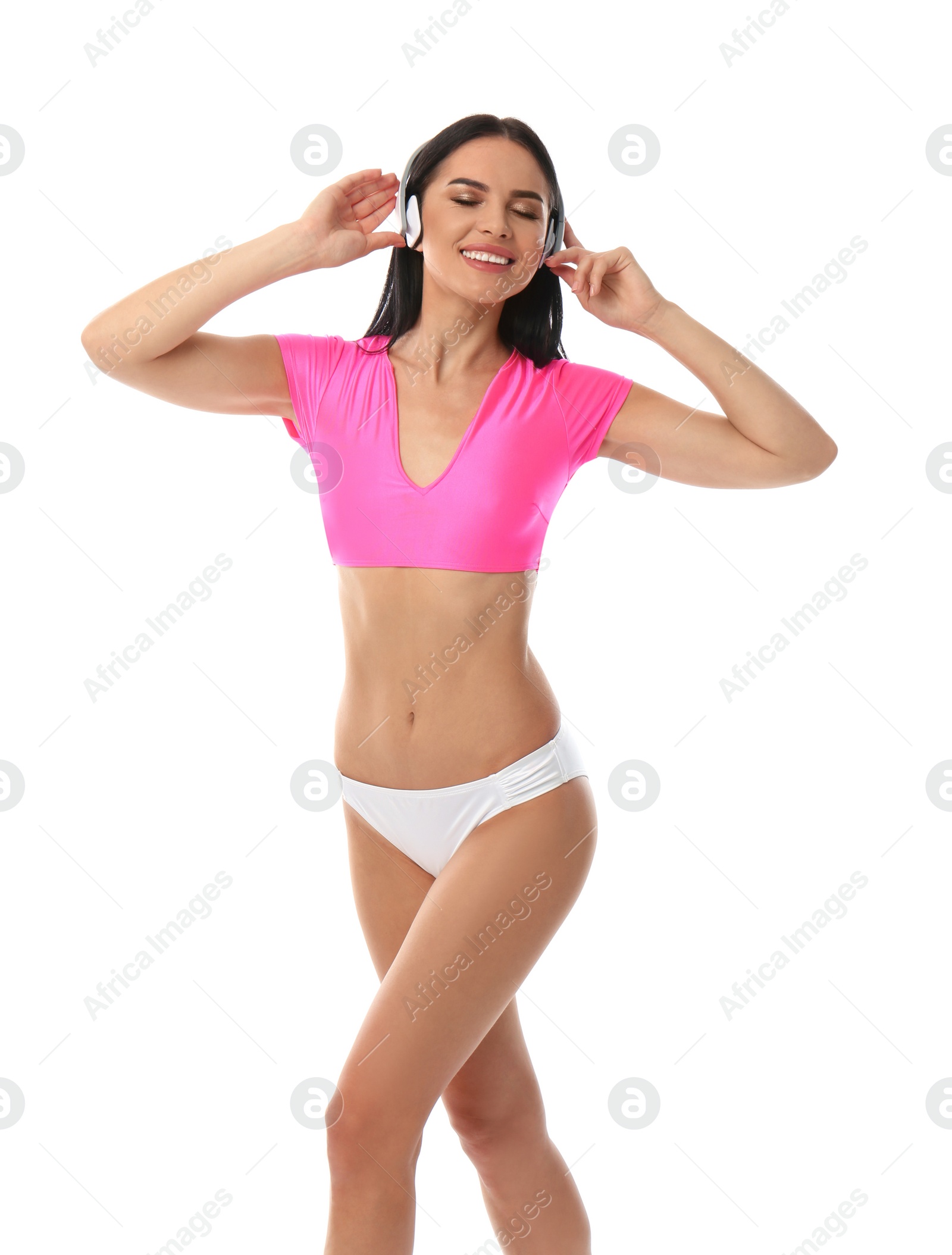 Photo of Beautiful young woman in stylish bikini with headphones on white background