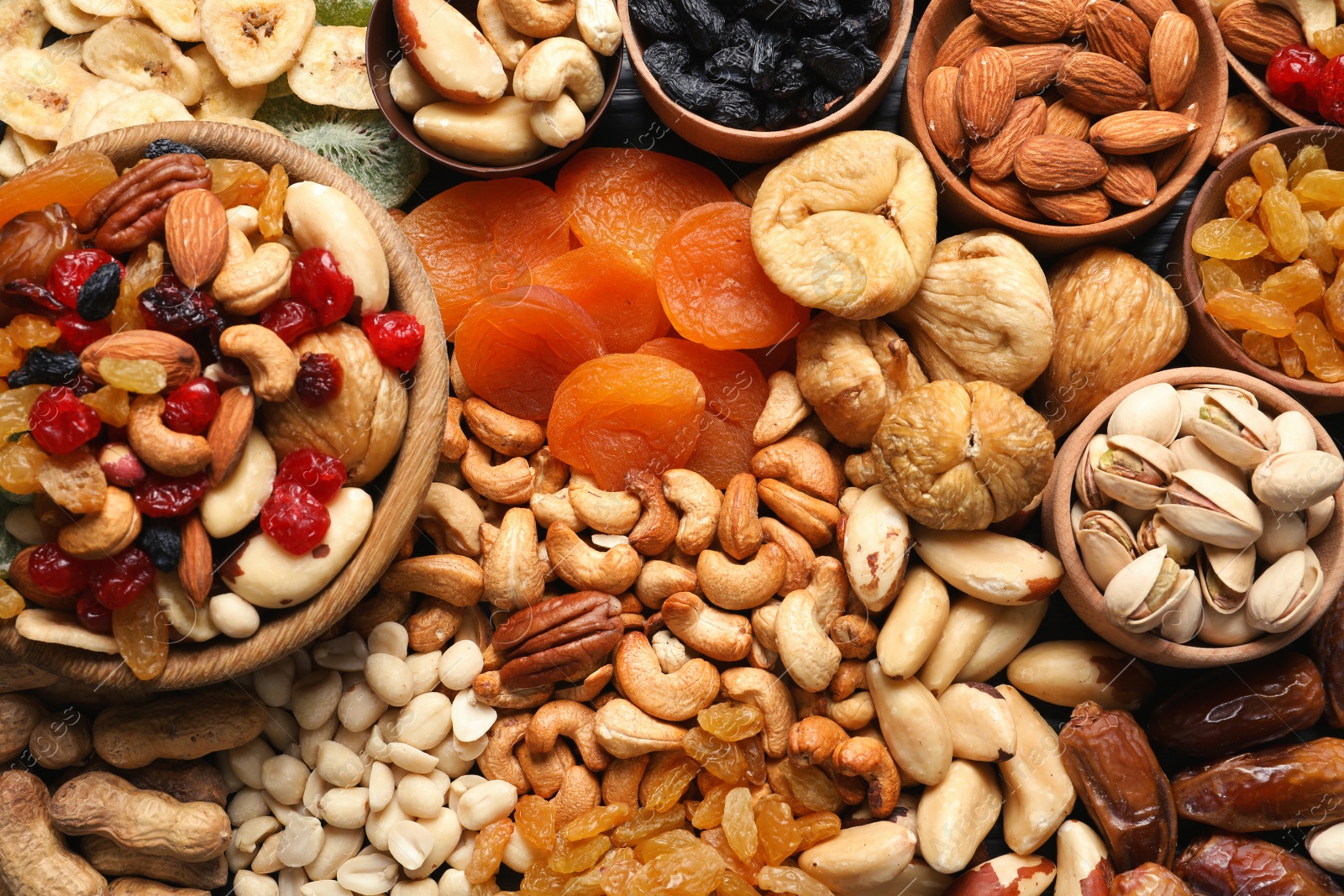 Photo of Composition of different dried fruits and nuts, top view