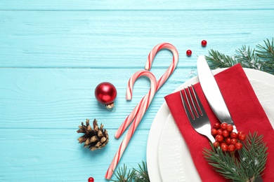 Photo of Christmas table setting on blue wooden background, top view. Space for text