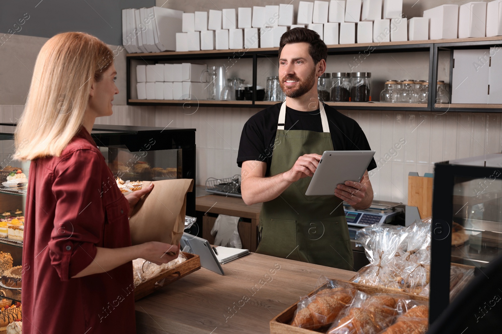 Photo of Woman buying fresh pastries in bakery shop