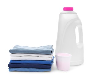 Photo of Stack of baby clothes and laundry detergents isolated on white