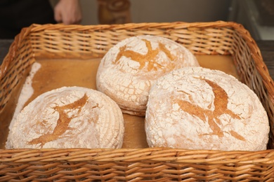 Freshly baked loaves of bread in wicker tray