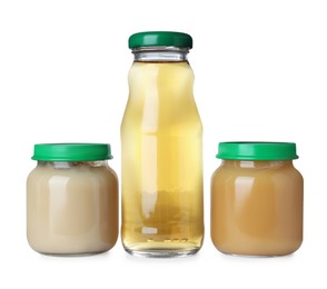 Photo of Baby food in jars near bottle of juice on white background