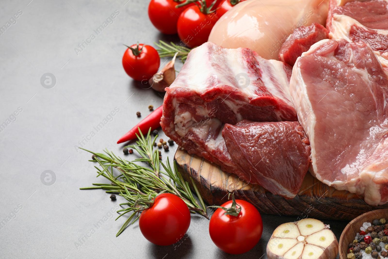 Image of Fresh raw meat and spices on grey table, closeup