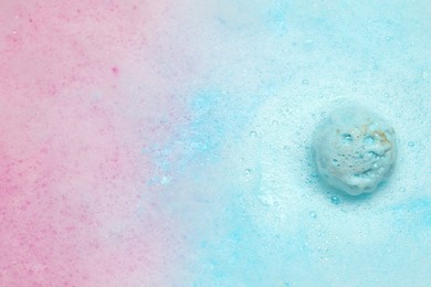 Light blue bath bomb dissolving in water. Space for text