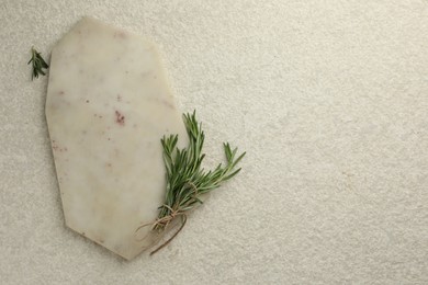 Photo of Cutting board and rosemary on white textured table, flat lay. Space for text