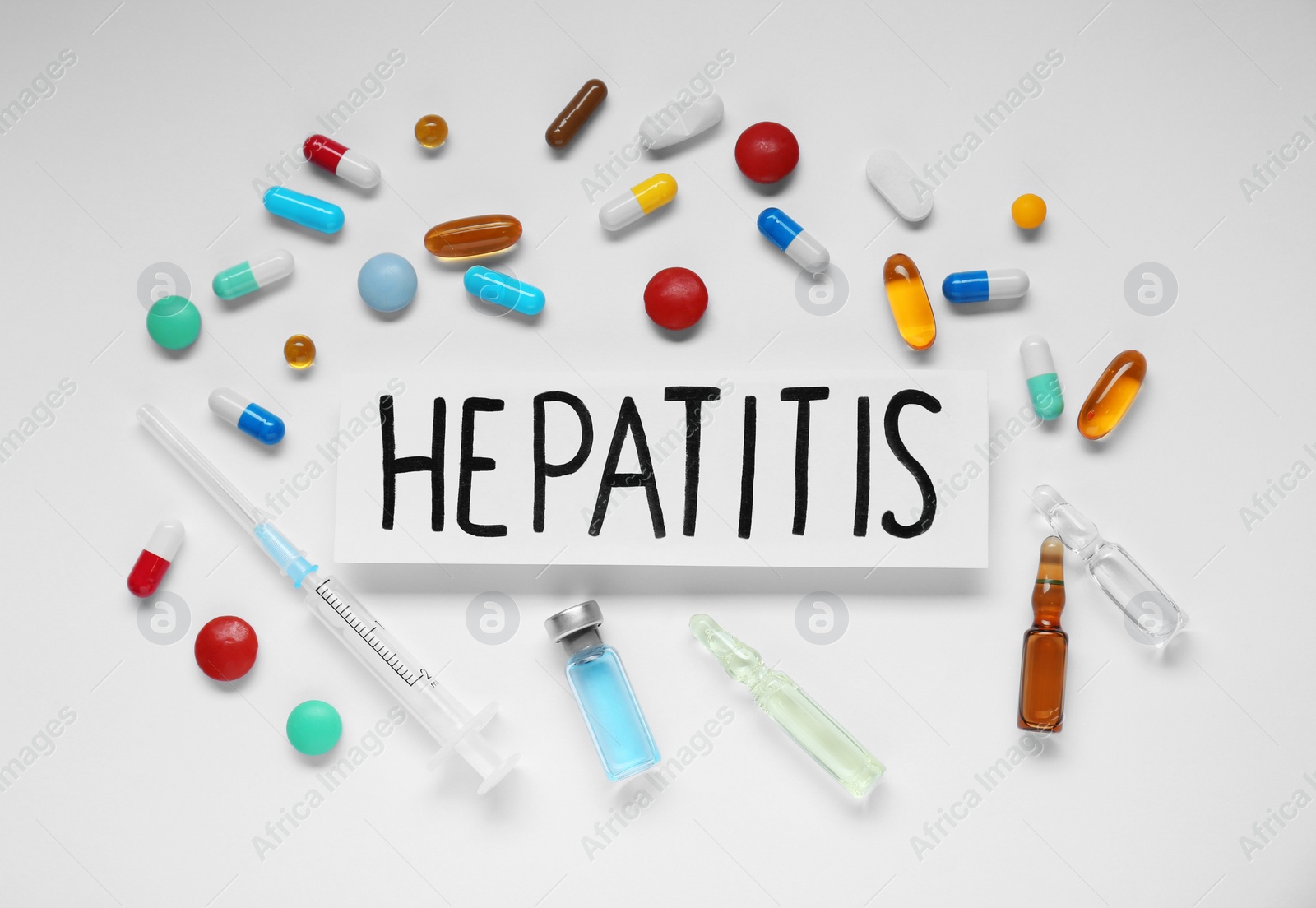 Photo of Word Hepatitis and medical supplies on white background, flat lay