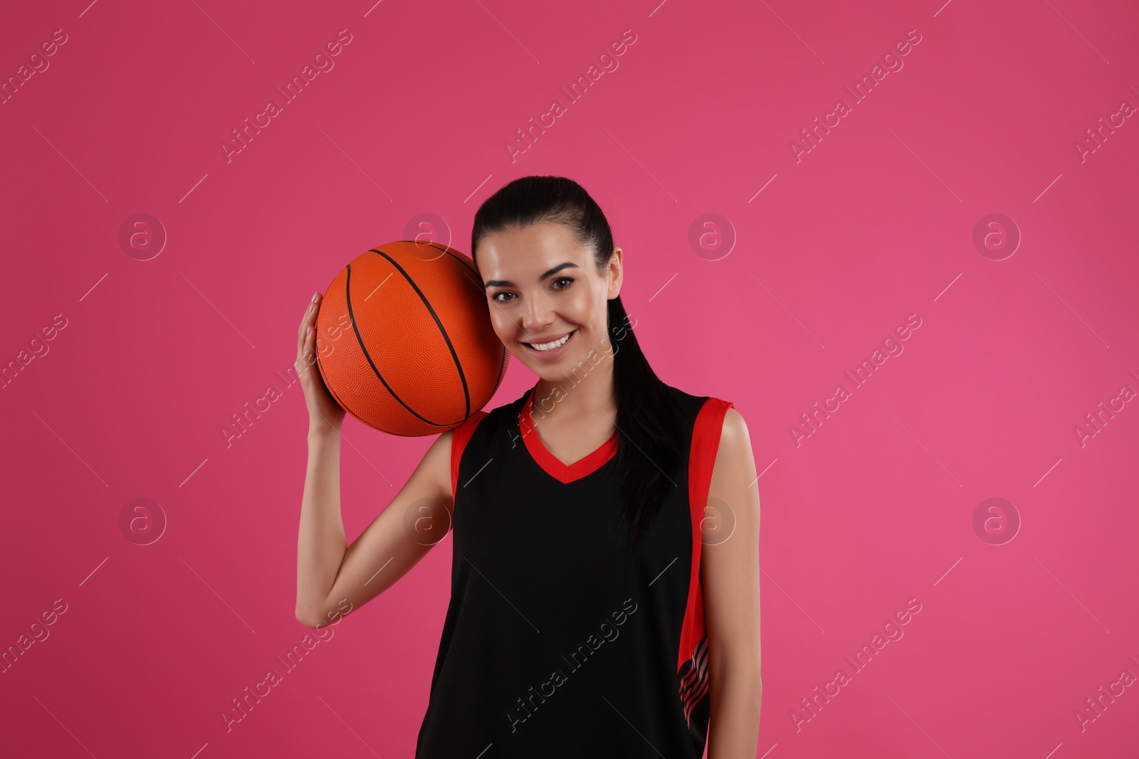 Photo of Basketball player with ball on pink background