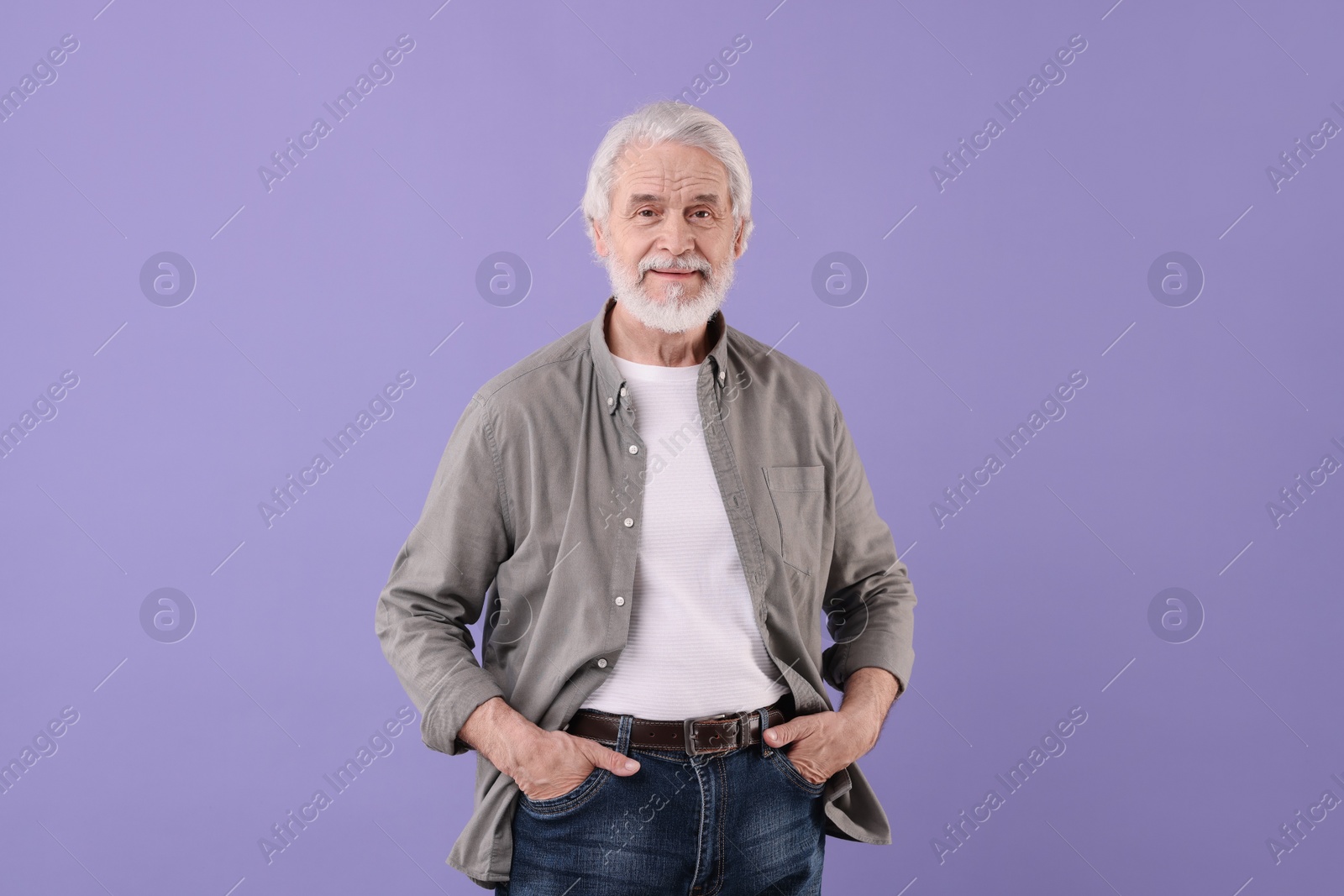 Photo of Portrait of stylish grandpa on purple background