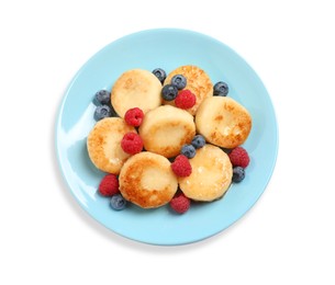 Photo of Delicious cottage cheese pancakes with fresh berries and honey on white background, top view