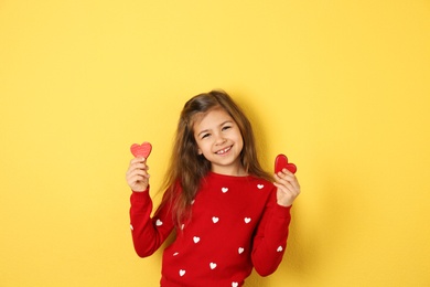 Photo of Portrait of girl with decorative hearts on color background