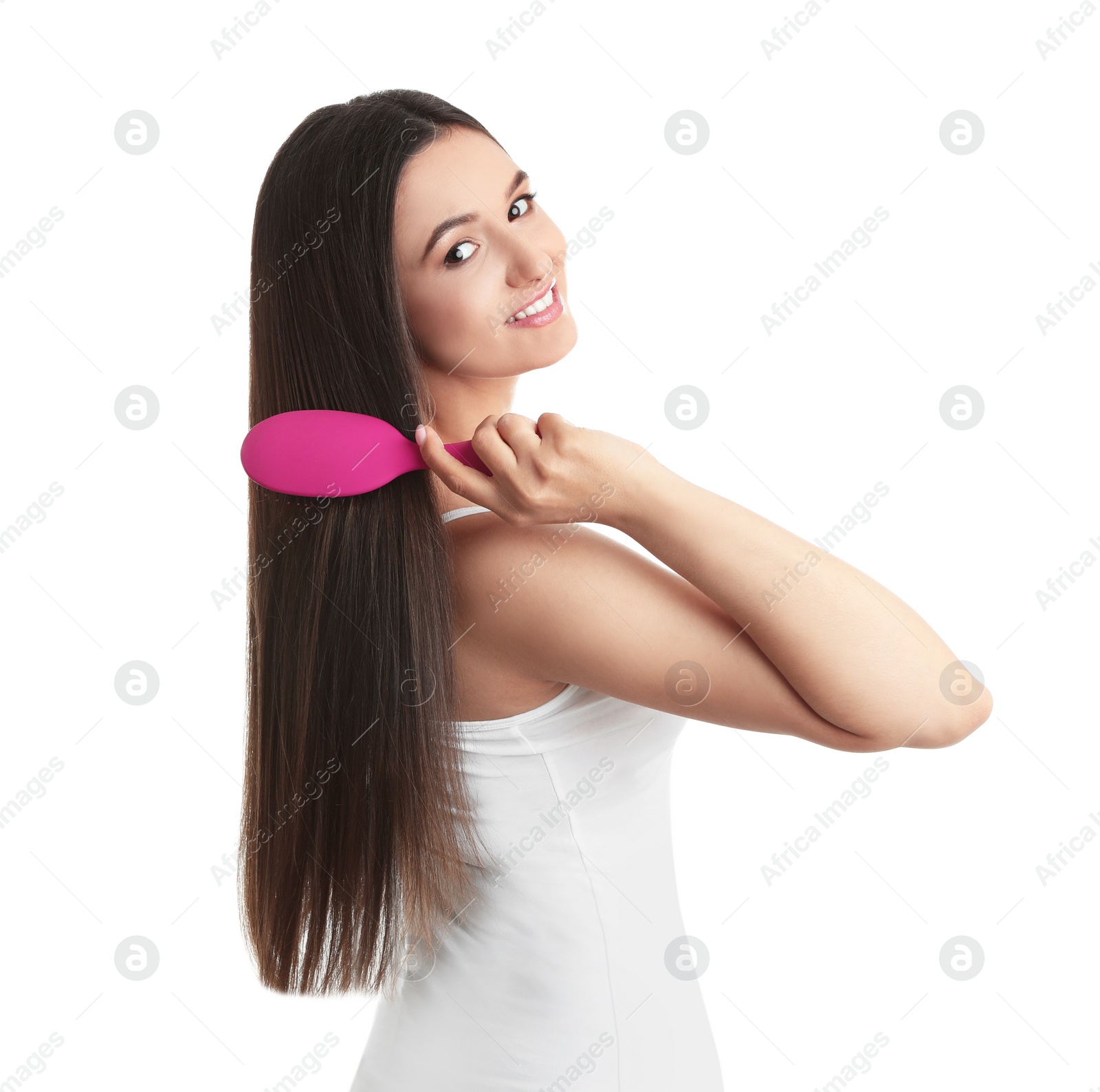 Photo of Beautiful young woman with hair brush on white background