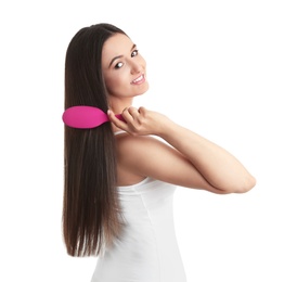 Photo of Beautiful young woman with hair brush on white background